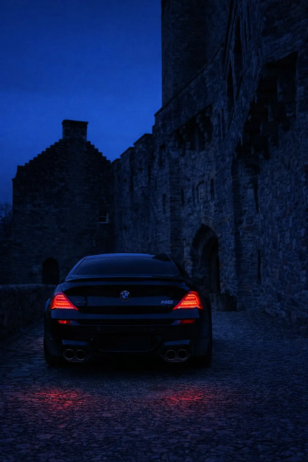 BMW M6 in a castle courtyard at night