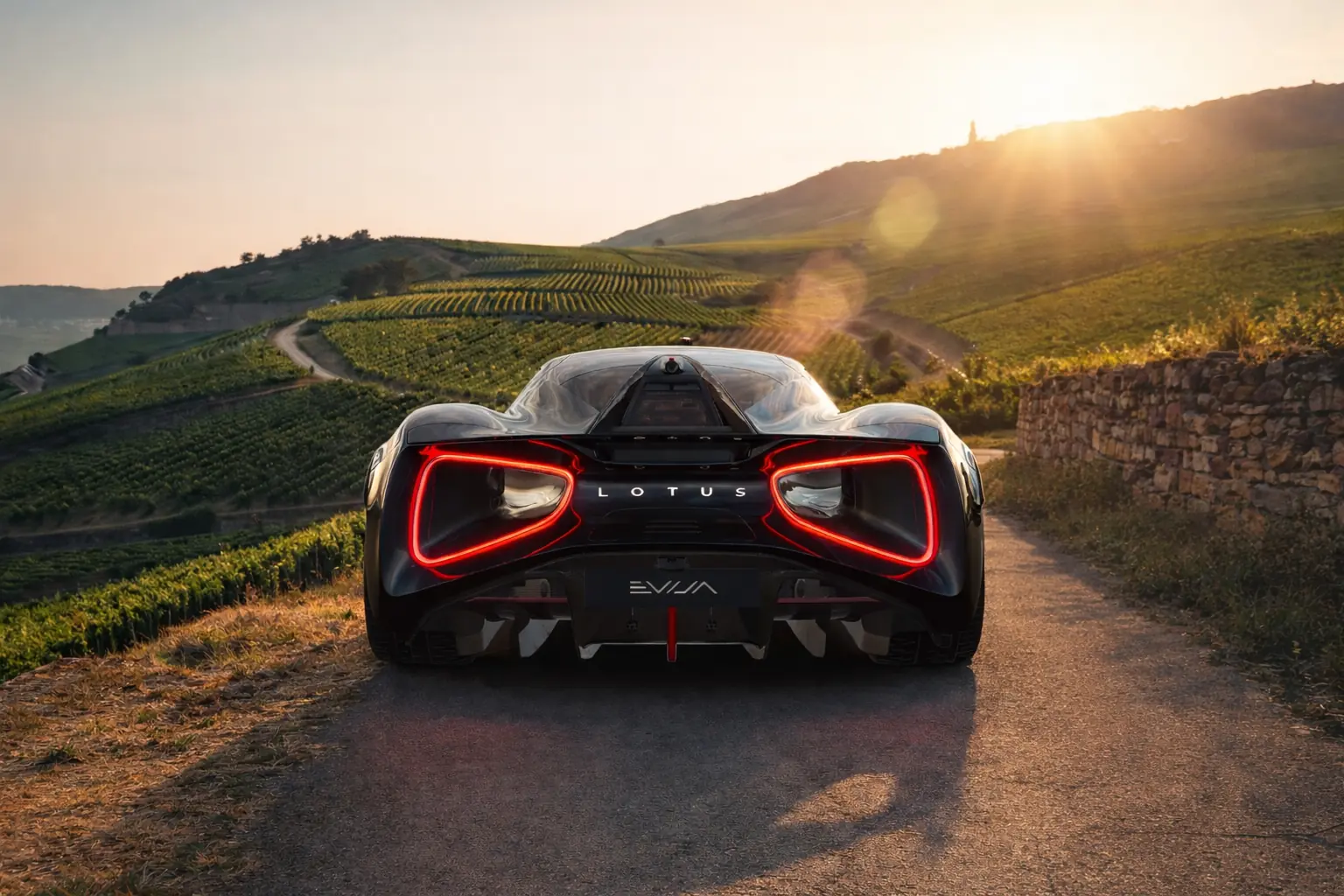 Lotus Evija on a vineyard road in morning sun