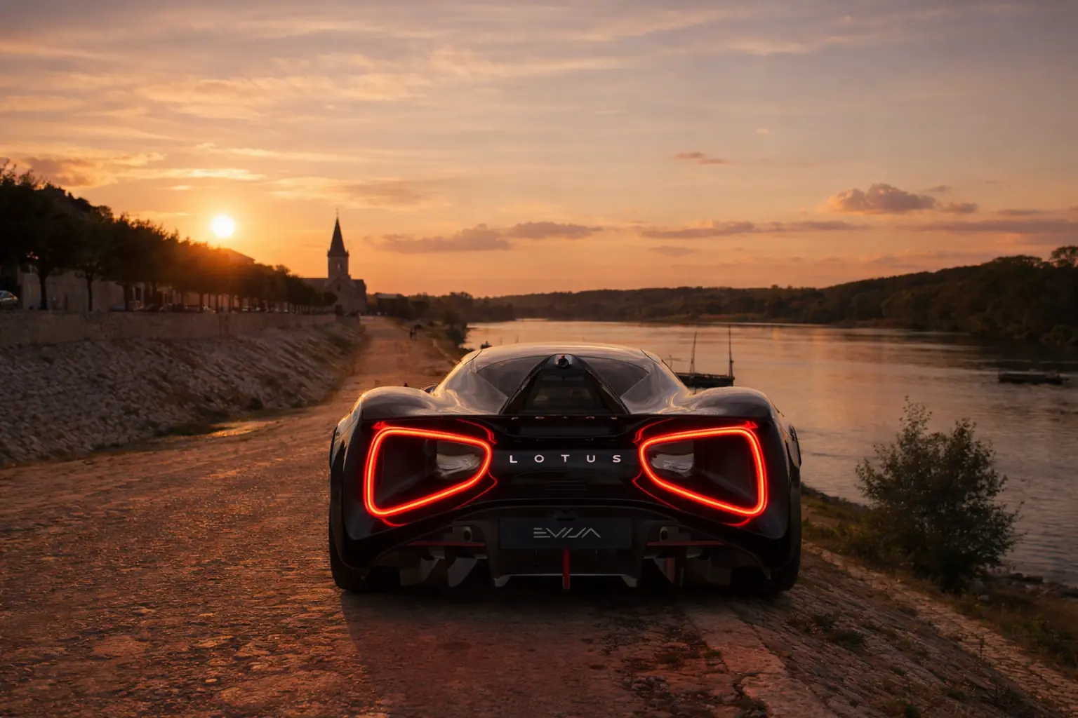 Lotus Evija on a riverside track at sunset